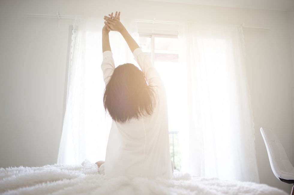 Cozy Moments at Home - stock photo
 early morning Asian Business girl wake up on Cozy bed room and soft flare filter Business and technology concept