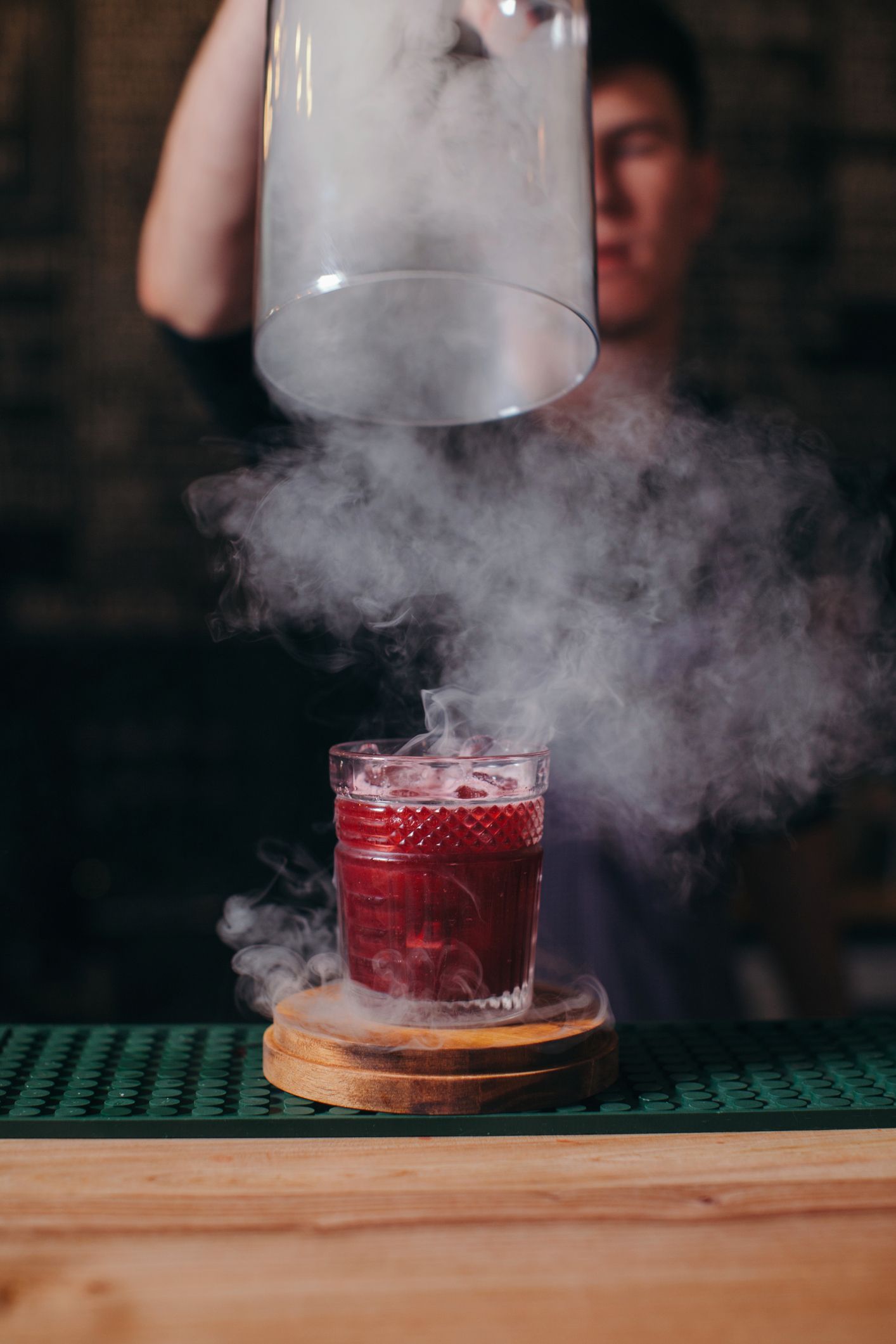 Barman preparing a smoky cocktail
