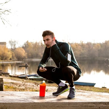 Exhausted runner resting near lake exhausted runner resting after run