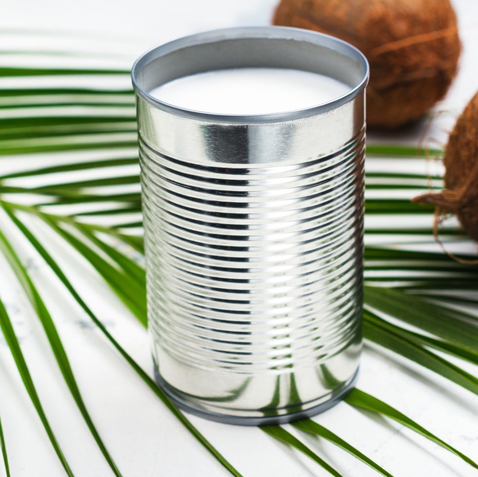 Opened tin can with coconut milk drink