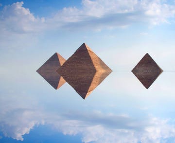 an abstract view of giza pyramids reflected in sky