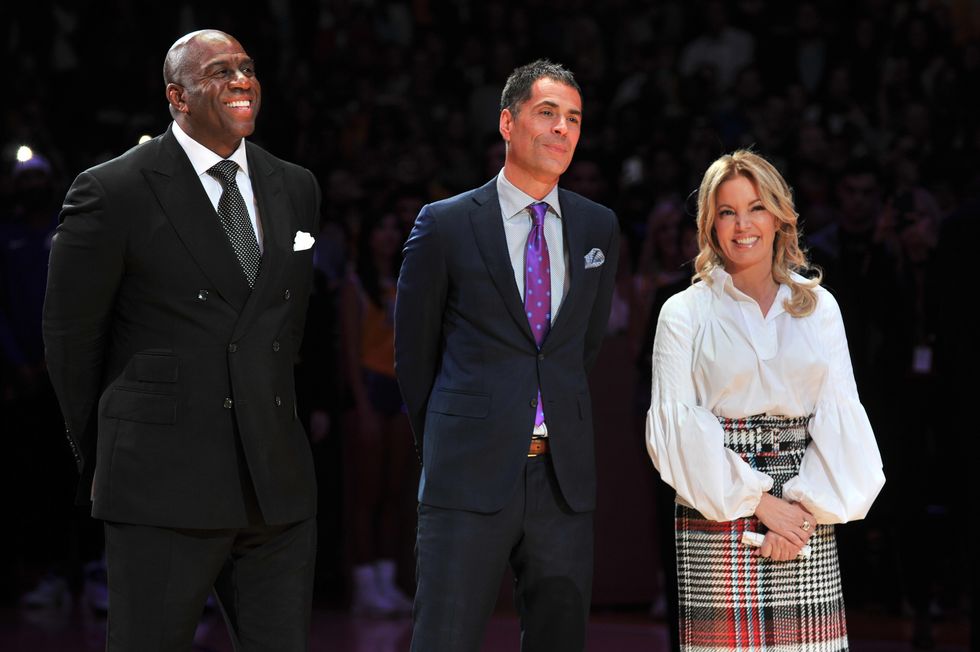 los angeles, ca   december 18 l r magic johnson, rob pelinka and jeanie buss attend kobe bryants jersey retirement ceremony during a basketball game between the los angeles lakers and the golden state warriors at staples center on december 18, 2017 in los angeles, california  photo by allen berezovskygetty images