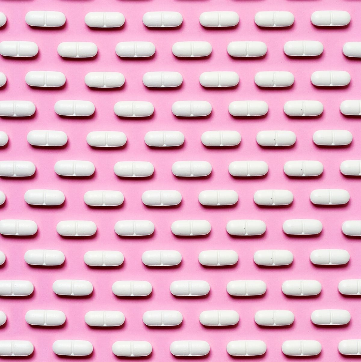 Full Frame Shot Of Pills Arranged On Pink Background