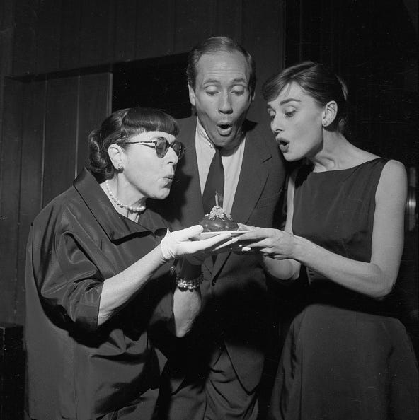 vintage birthday photos left to right: hollywood costume designer edith head (1897 1981), american actor mel ferrer (1917 2008) and his wife, actress audrey hepburn (1929 1993), blowing out the candle on heads birthday cake at a don hartman party for ferrer and hepburn at the beverly hills hotel, los angeles, california, circa 1955. (photo by darlene hammond/hulton archive/getty images)