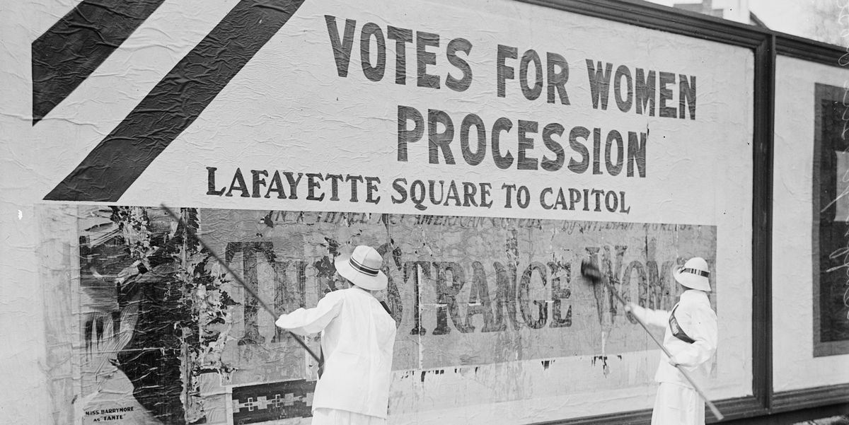 Suffragettes uses Long Brushes to Post a Billboard announcing a "Votes" For Women" Parade
