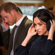 britains prince harry and his fiancée us actress meghan markle listen to a broadcast through headphones during a visit to reprezent 1073fm community radio station in brixton, south west london on january 9, 2018    afp photo  pool  dominic lipinski        photo credit should read dominic lipinskiafp via getty images