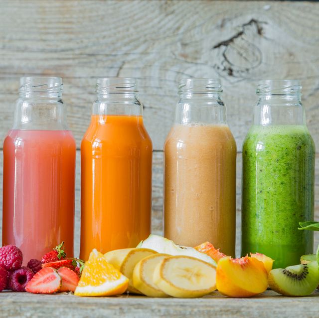 selection of colourful smoothies on rustic wood background, copy space