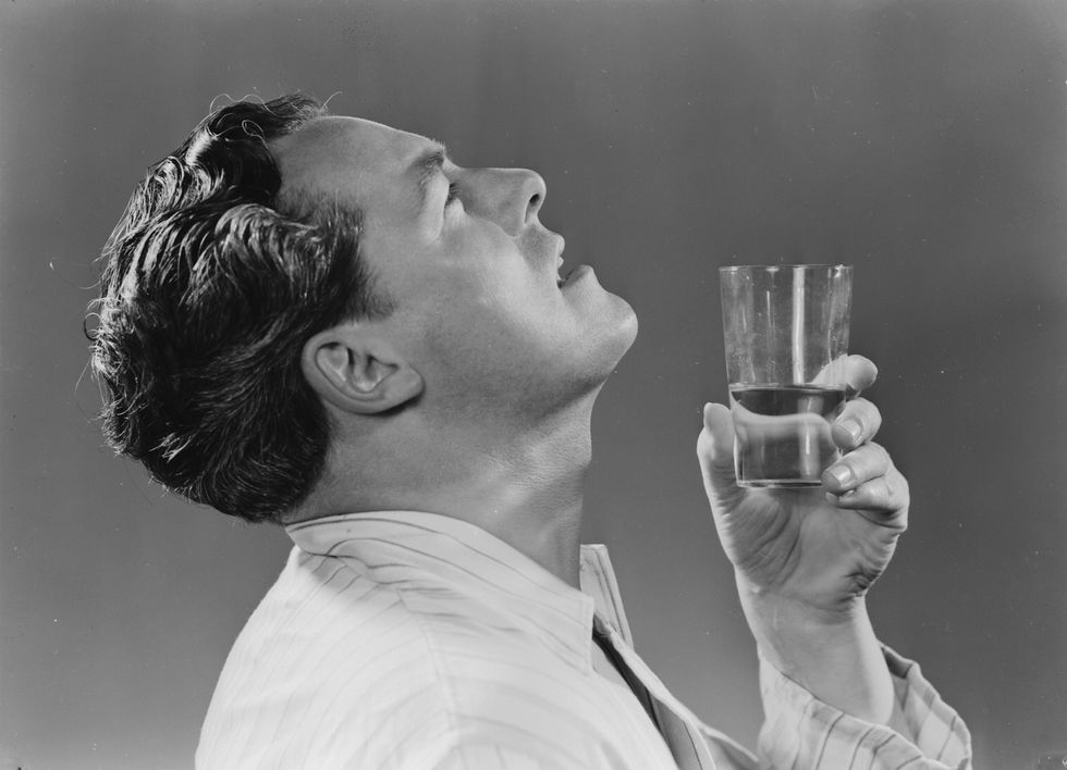 england   august 07  a photograph of a man gargling with a glass of water, taken by photographic advertising limited in 1951 photographic advertising limited, founded in 1926, created multi purpose stock images with the potential for selling a range of products whilst enjoying its greatest success during the 1930s, it continued in business until 1977 their trademark, the staged studio photograph resembling a film still, was its selling point and, later, its downfall sophisticated, adaptable and generic, this kind of image gradually fell out of favour as clients increasingly demanded targeted advertising campaigns with specific photographs  photo by ssplgetty images