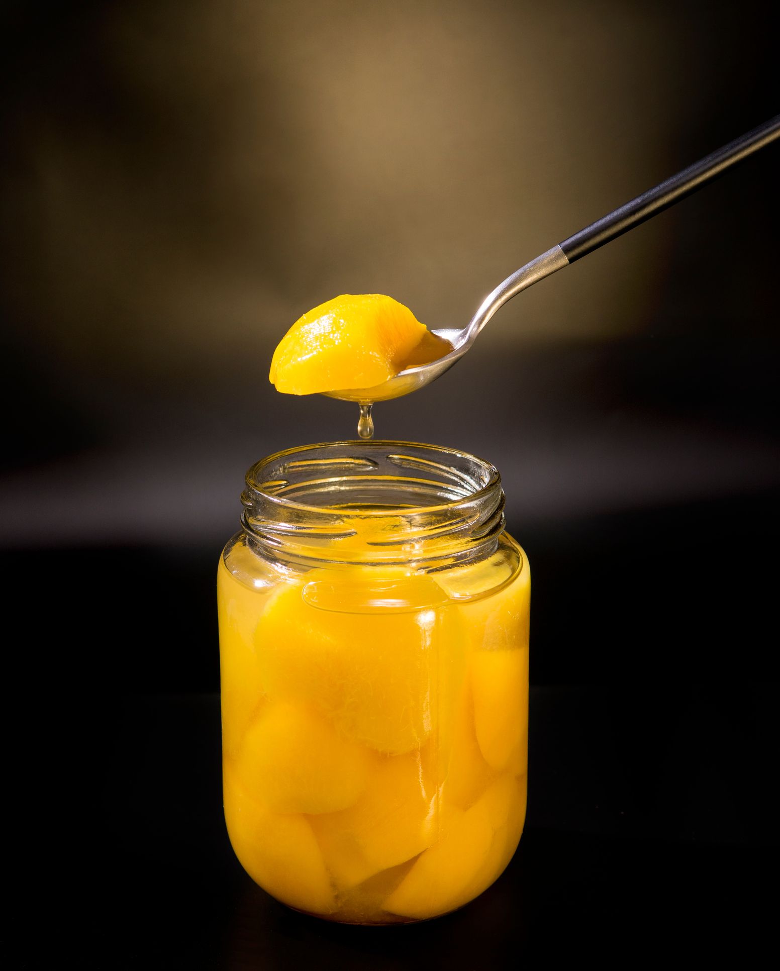Close-Up Of Canned Peaches In Jar