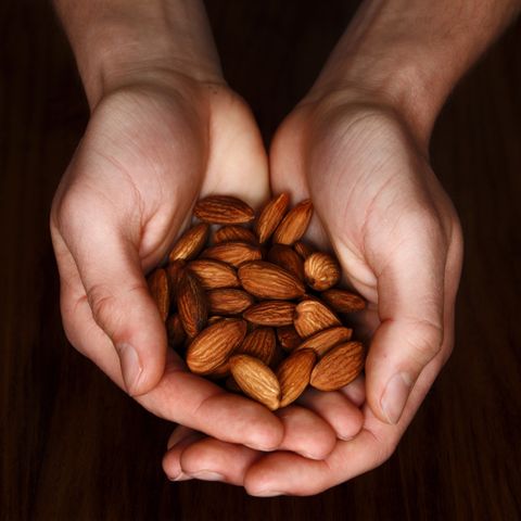 Cropped Hands Holding Almonds
