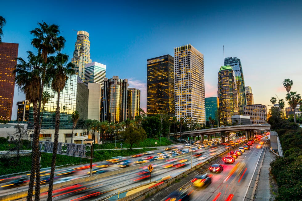 traffic on highway 110 in downtown los angeles skyline with office buildings and skyscrapers moody sky at dusk california, usa