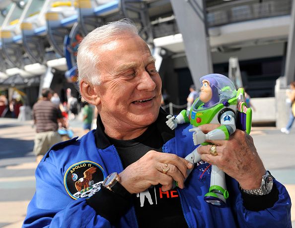 lake buena vista, fl   october 02  in this handout photo provided by disney, apollo 11 astronaut buzz aldrin poses oct 2, 2009 at the magic kingdom in lake buena vista, fla with the 12 inch tall buzz lightyear toy that spent 15 months in space onboard the international space station iss  aldrin and the space ranger toy were joined oct 2, 2009 by iss expedition 18 astronaut michael fincke in a celebratory homecoming parade in front of thousands of guests at the walt disney world theme park  disney parks and nasa sent the buzz lightyear toy into space in 2008 as part of an educational initiative to encourage students to pursue studies in science, technology, engineering and mathematics  the toy returned to earth sept 11, 2009 aboard space shuttle discovery sts 128  photo by garth vaughandisney via getty images