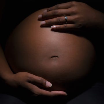 a person holding a baby's stomach