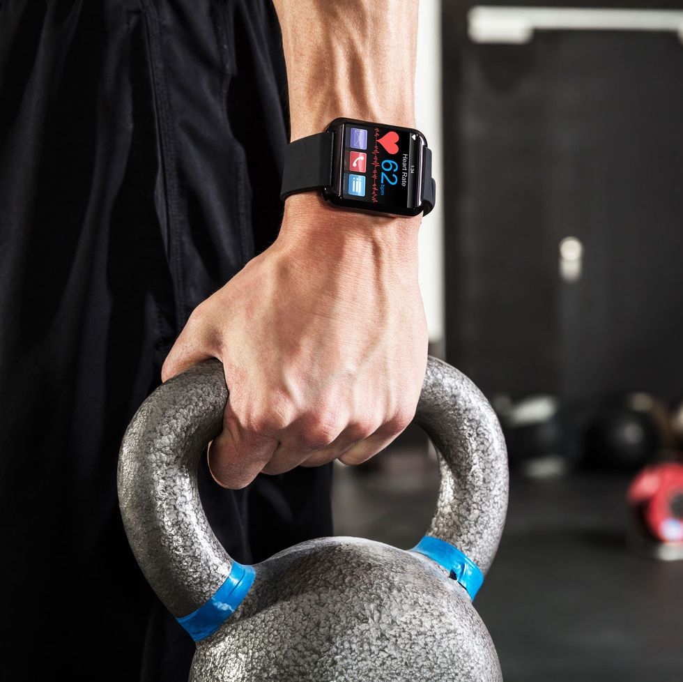 hand with smartwatch and kettlebell