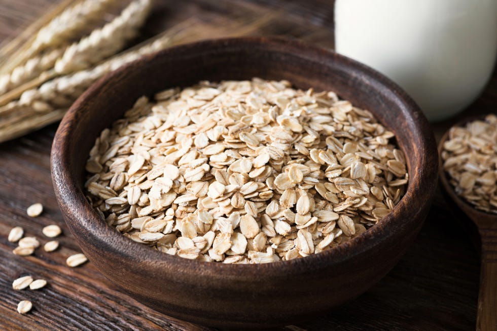 rolled oats in wooden bowl on old wooden table rustic style healthy eating, healthy lifestyle, dieting and fitness menu concept