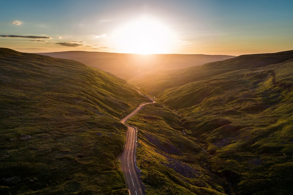 aerial view of sunrise over buttertubs pas in yorkshire dales national park