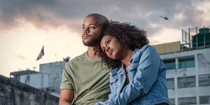 Young couple sitting on rooftop