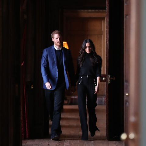 topshot   britains prince harry l and his fiancée us actress meghan markle walk through the corridors of the palace of holyroodhouse on their way to a reception for young people in edinburgh, during their visit to scotland on february 13, 2018
the reception celebrates youth achievements, marking scotlands year of young people 2018, an initiative that aims to inspire scotland through its young people celebrating their achievements, strengthening their voice on social issues and creating new opportunities for them to shine  afp photo  pool  andrew milligan        photo credit should read andrew milliganafp via getty images