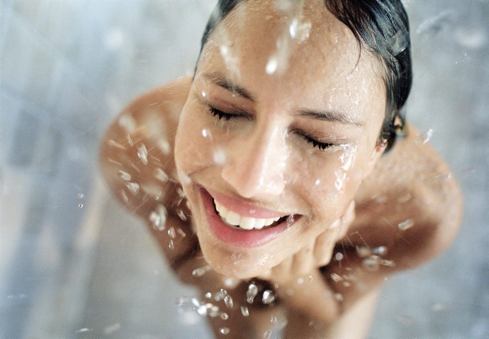 woman washing face in shower