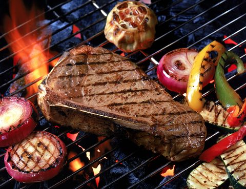 Steak with vegetables on grill