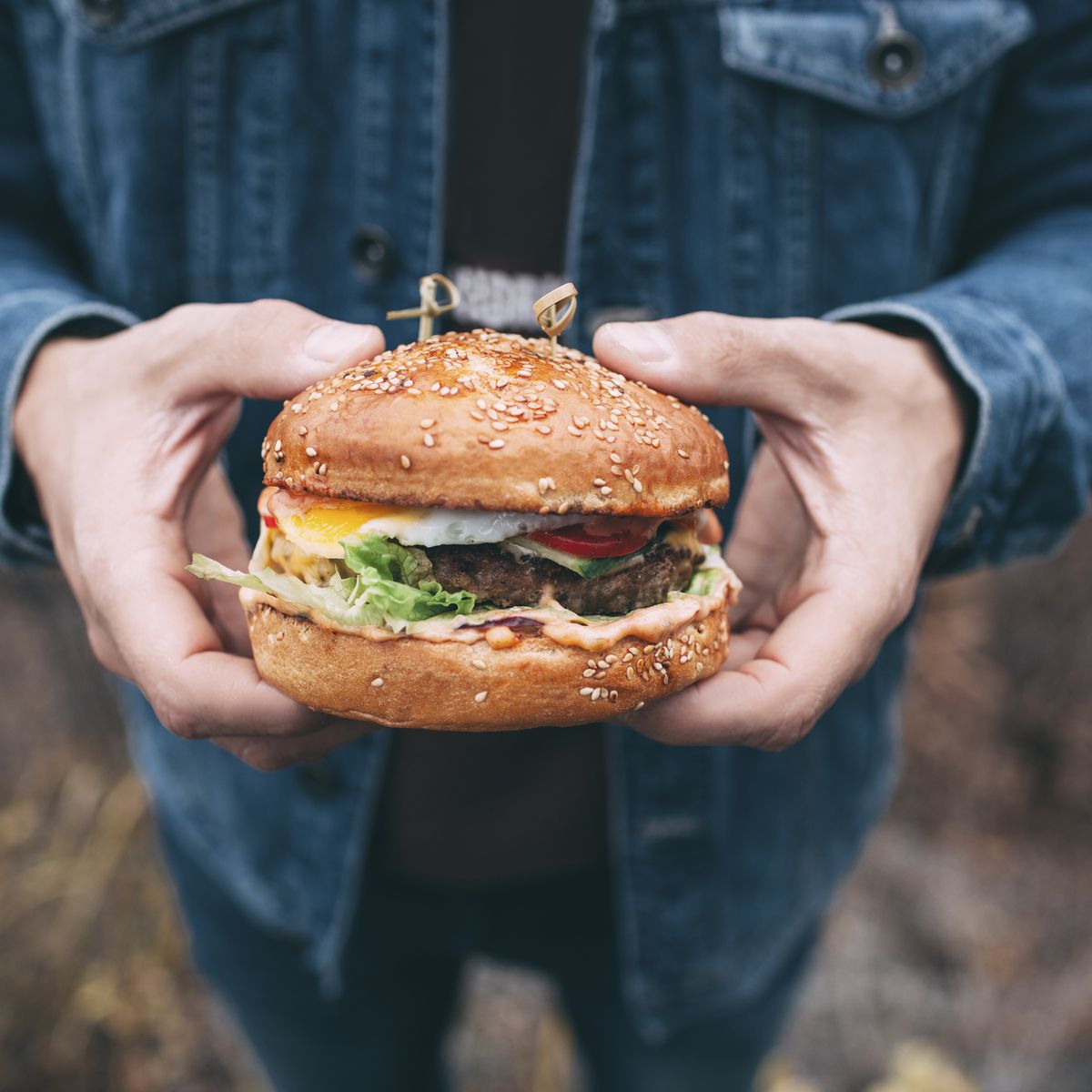 man holding a burger men's health