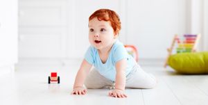 cute infant baby crawling on the floor at home