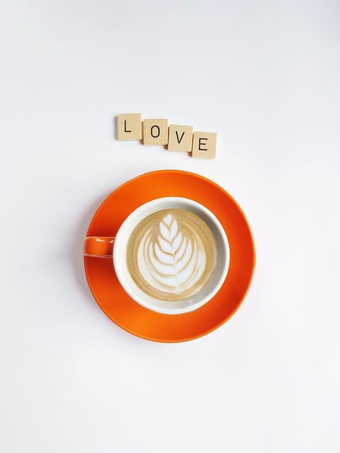 Directly Above Shot Of Coffee By Love Text Over White Background