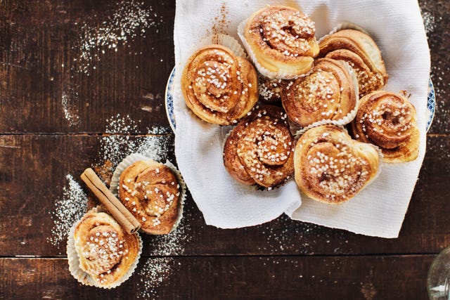 cinnamon rolls in a basket on a wooden table