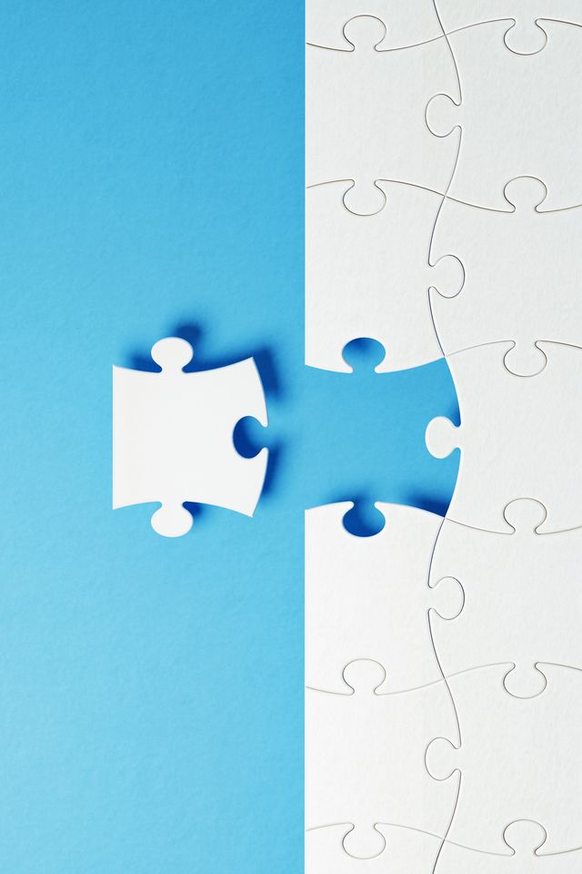 Puzzle Concept - White Jigsaw Puzzle Pieces On Blue Background