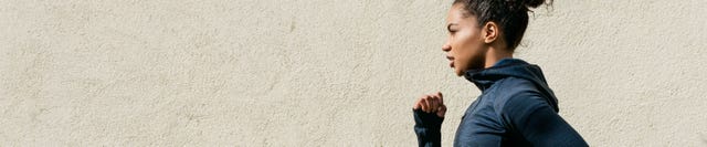 Woman Running Against Wall