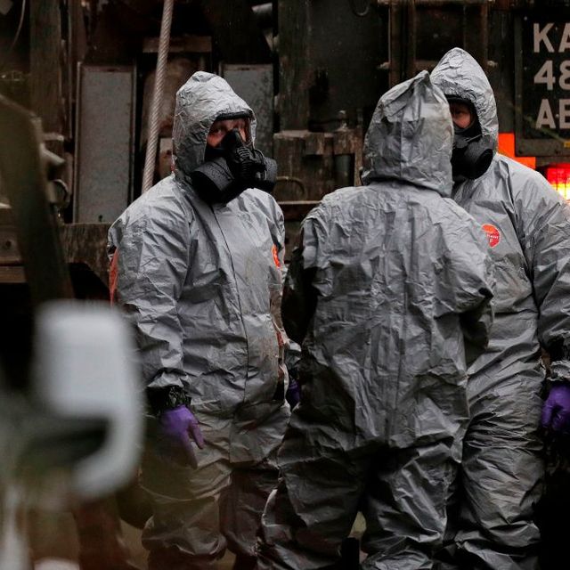 Military personnel wearing protective coveralls work to remove a vehicle as part of the ongoing investigation in connection with the major incident sparked after a man and a woman were apparently poisoned in a nerve agent attack a week ago on March 12, 2018 near Middle Winterslow. British Prime Minister Theresa May chaired a meeting of her national security team after weekend confirmation that traces of a nerve agent used in the attempted murder of former Russian spy Sergei Skripal, and his daughter Yulia, were found in a pub and a restaurant they visited.