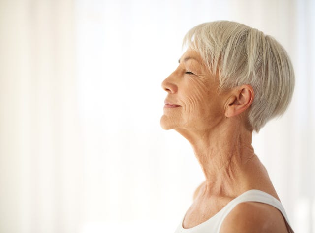 cropped shot of a content senior woman at home
