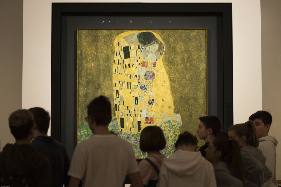 vienna, austria   march 14 visitors are seen as they admire oil painting kiss at the world's largest collection of gustav klimt at the upper belvedere, belvedere palace in vienna, austria on march 14, 2018 the belvedere holds the world's largest gustav klimt collection including the famous two masterpieces from his golden period, kiss lovers and judith klimt's collection was previously grouped in two rooms, but recently, gustav klimt collection has been integrated into a general art historical context combined with works by other artists from the same period photo by omar marquesanadolu agencygetty images