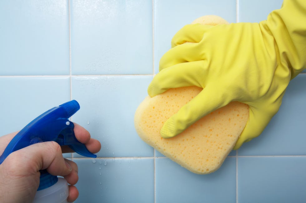 cleaning tiles with a sponge and spray cleaner
