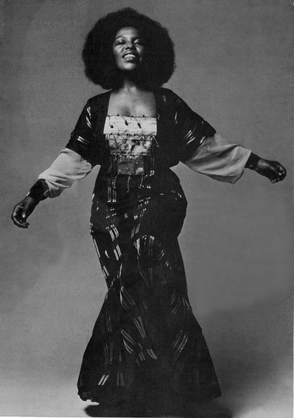 a figure wearing traditional attire showcasing a blend of styles