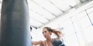 Punching bag, Boxing glove, Arm, Boxing, Physical fitness, Sport venue, Room, Leg, Sports training, Muscle, 
