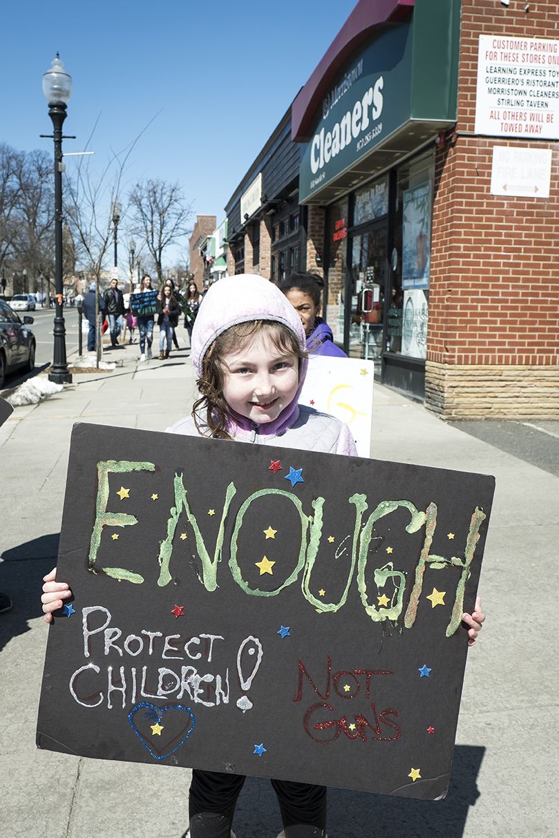 morristown, nj march 24 thousands of demonstrators outside the morristown town hall with a young protestor holding up a sign "enough protect children not guns" during the march for our lives in morristown, new jersey, us on saturday, march 24, 2018 thousands of demonstrators, including students, teachers and parents gathered in morristown, nj for the antigun violence rally after the events in marjory stoneman douglas high school which killed 17 people more than 800 related events are taking place around the world to call for legislative action to address school safety and gun violence photo by ira l blackcorbis via getty images