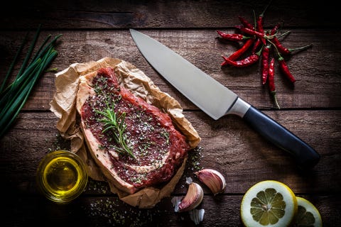 Raw beef steak on rustic wooden table