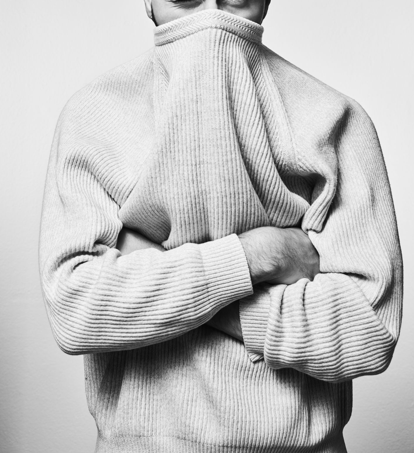Man with jumper covering face