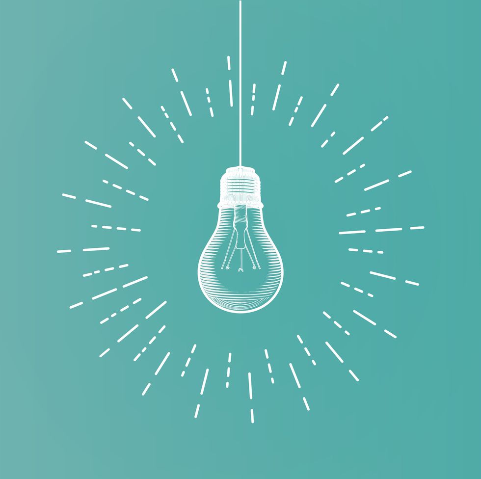 white line art light bulb illustration on green background with glowing starburst