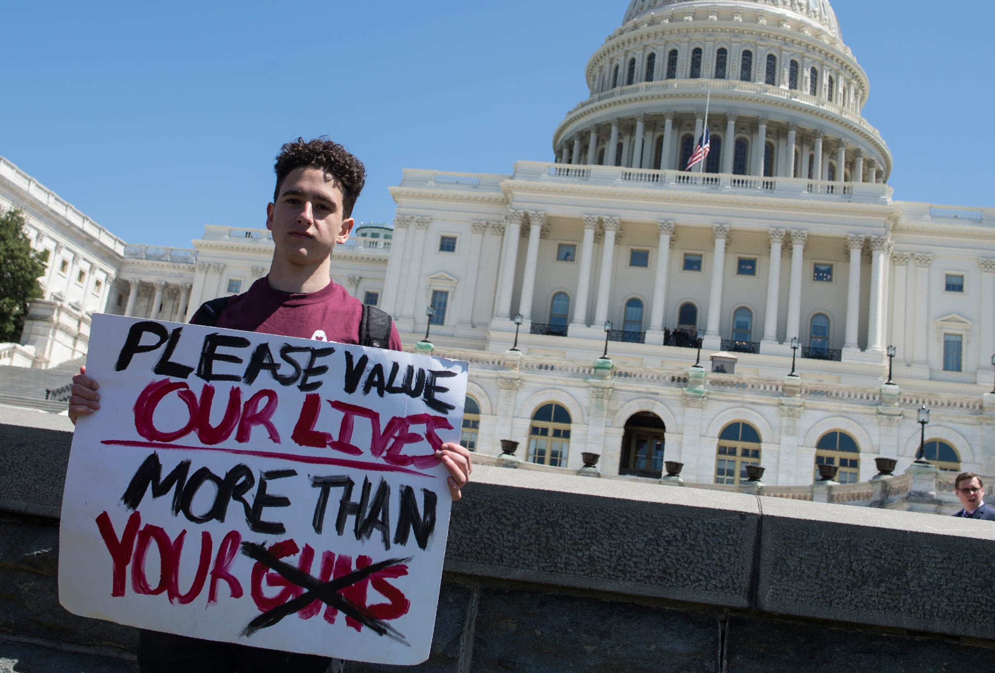 topshot amit dadon, a graduate in 2017 from marjory stoneman douglas high school, poses for a photo on the west lawn of the us capitol after rallying with several hundred fellow students to call for stricter gun laws in washington, dc on april 20, 2018 to protest gun violence students across the us were urged to walk out of classes to mark the 19th anniversary of the 1999 school shooting at columbine high school in colorado which left 13 people dead the walkout has been organized by students at marjory stoneman douglas high school in parkland, florida, where 14 students and three adult staff members were killed by a troubled former classmate on february 14, 2018 photo by andrew caballero reynolds afp photo credit should read andrew caballero reynoldsafp via getty images