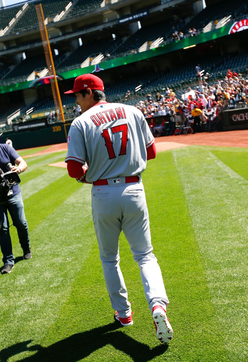 oakland, ca april 1 shohei ohtani 17 of the los angeles angels of anaheim heads to the bullpen to warm up prior to the game against the oakland athletics at the oakland alameda coliseum on april 1, 2018 in oakland, california the angels defeated the athletics 7 4 photo by michael zagarisoakland athleticsgetty images local caption shohei ohtani