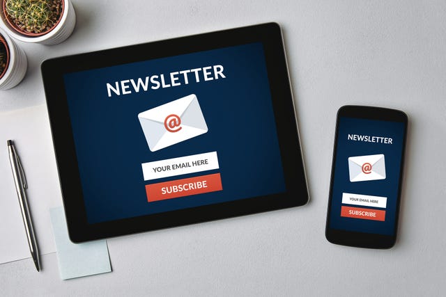 subscribe newsletter concept on tablet and smartphone screen over gray table all screen content is designed by me flat lay