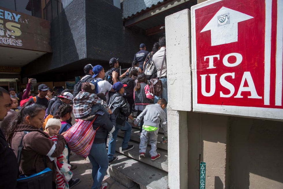 tijuana, mexico april 29 members of a caravan of central americans who spent weeks traveling across mexico walk from mexico to the us side of the border to ask authorities for asylum on april 29, 2018 in tijuana, baja california norte, mexico more than 300 immigrants, the remnants of a caravan of central americans that journeyed across mexico to ask for asylum in the united states, have reached the border to apply for legal entry photo by david mcnewgetty images