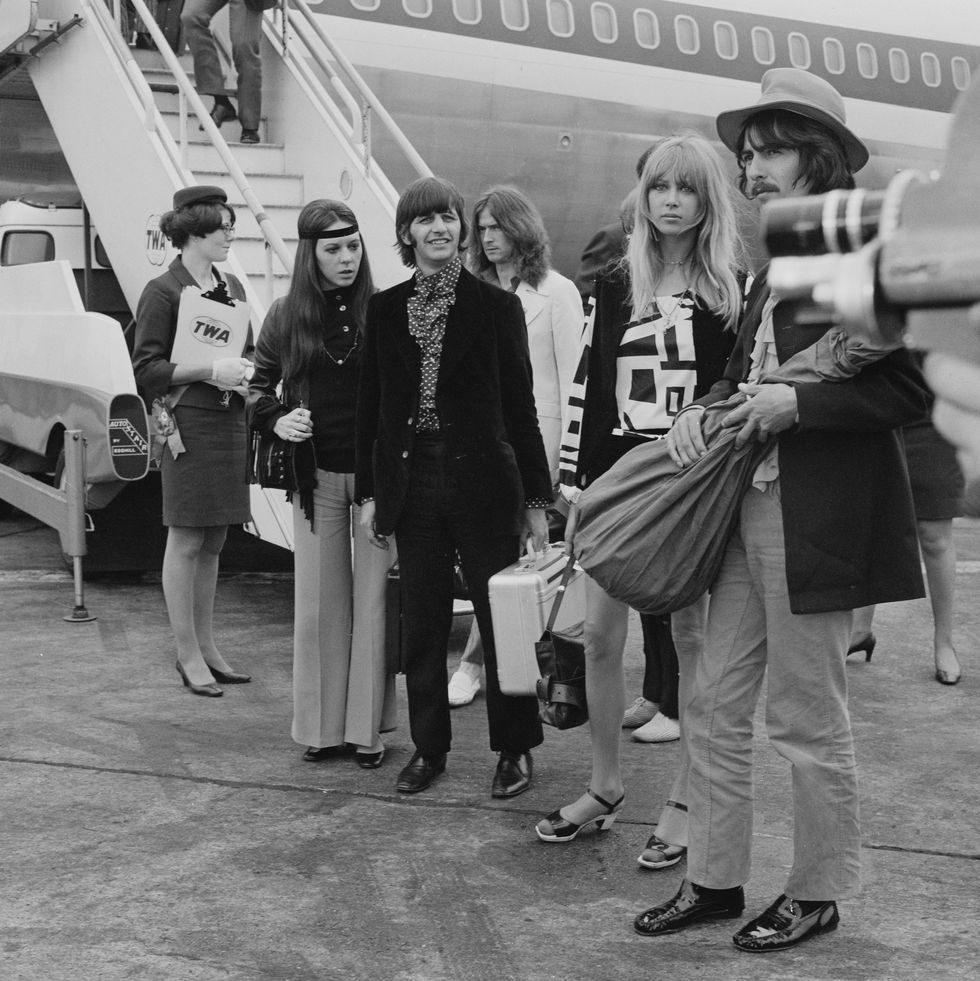 Eric Clapton (in the white suit,) Ringo Starr and his wife Maureen Cox and George Harrison and his wife Pattie Boyd at Heathrow Airport, in London on June 26, 1968