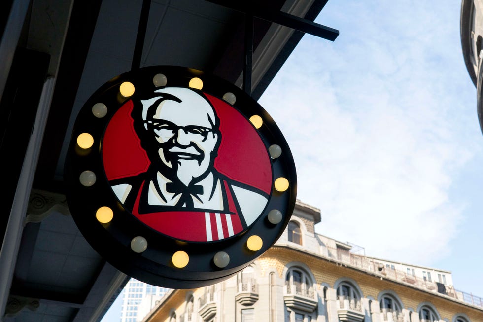 Colonel Sanders portrait on logo of a KFC restaurant.