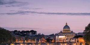 dusk on tiber river with bridge umberto i and basilica di san pietro in the background, rome, lazio, italy