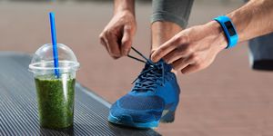 Nutrition. Male Legs With Healthy Detox Drink At Outdoor Workout