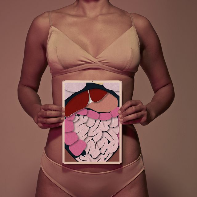 female holding tablet in front of body to display coloured x ray illustrations made out of hand made paper structures