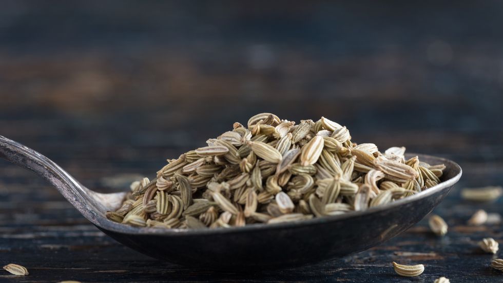 Close-Up Of Fennel Seed In Spoon On Wooden Table